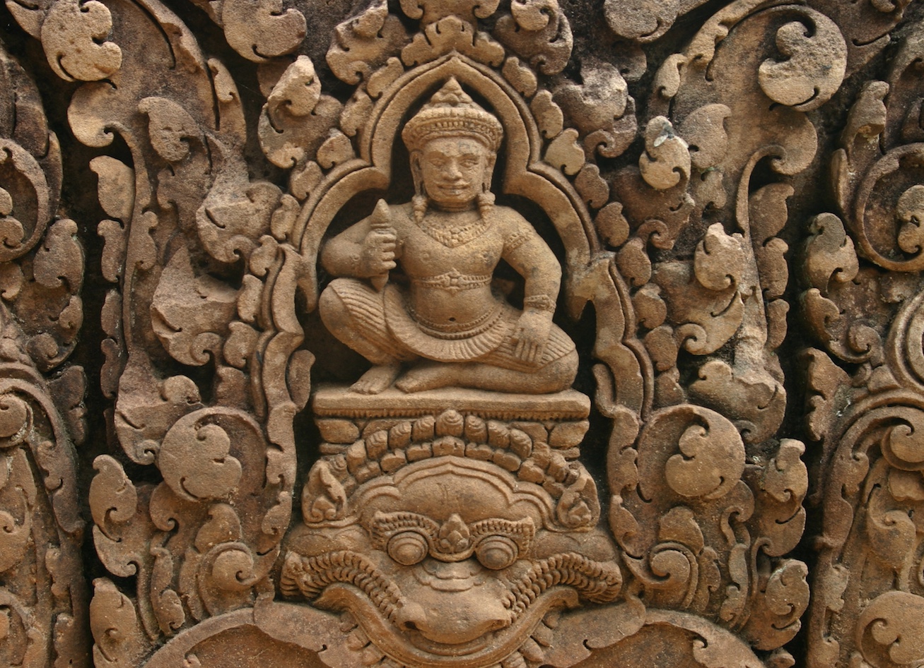 Photo of a stone statue surrounded by filigree